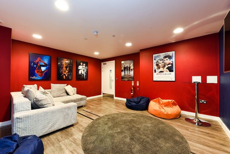 Bold red feature wall lounge by Paint and Maintain